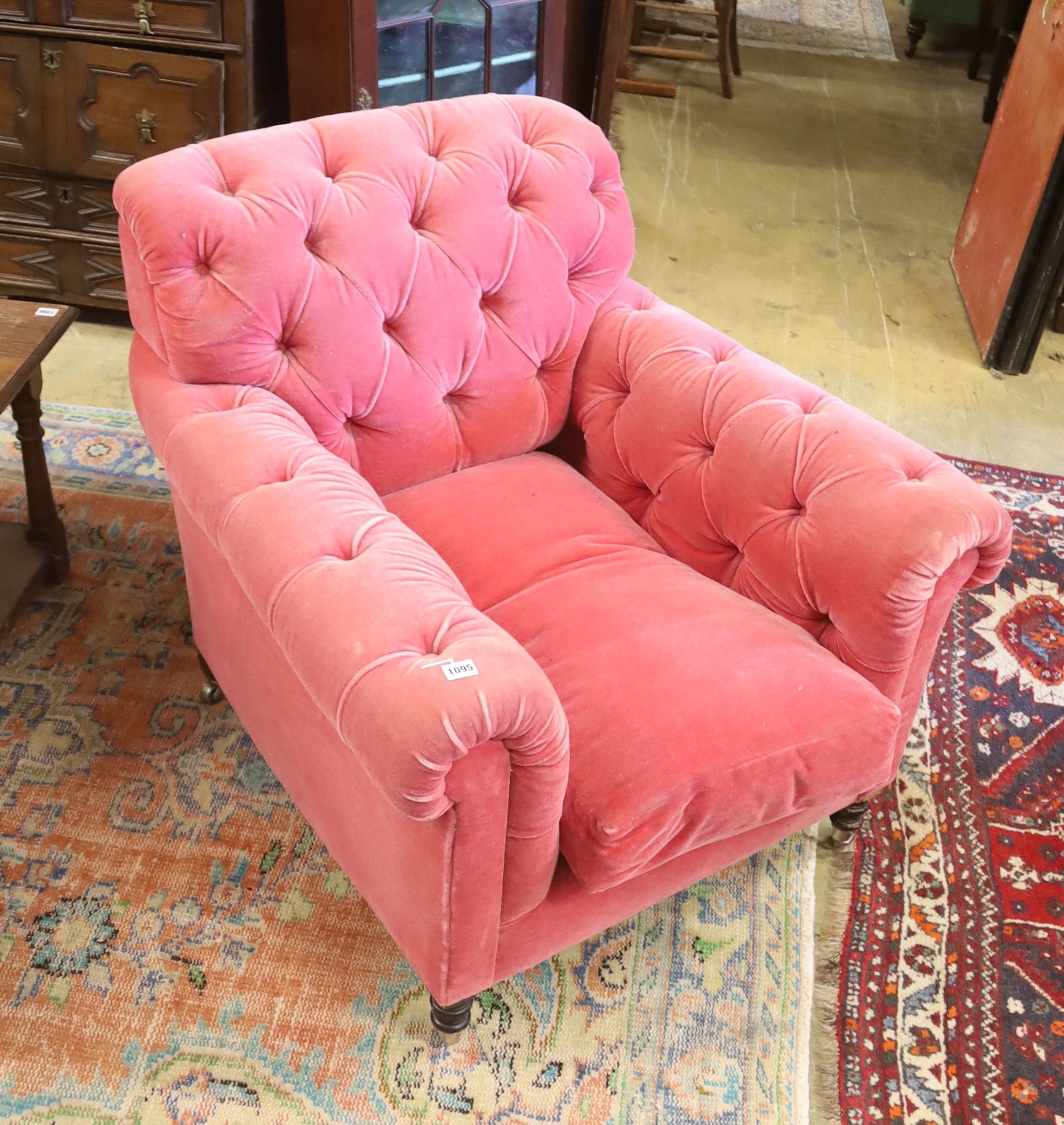 A George Smith armchair upholstered in buttoned pink fabric on turned legs, width 86cm, depth 95cm, height 80cm